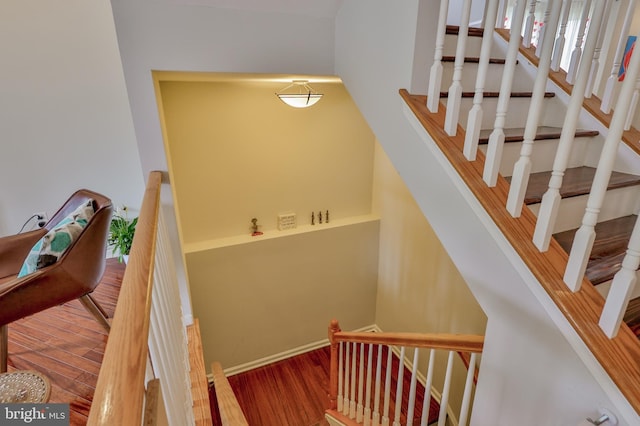 stairway featuring wood finished floors