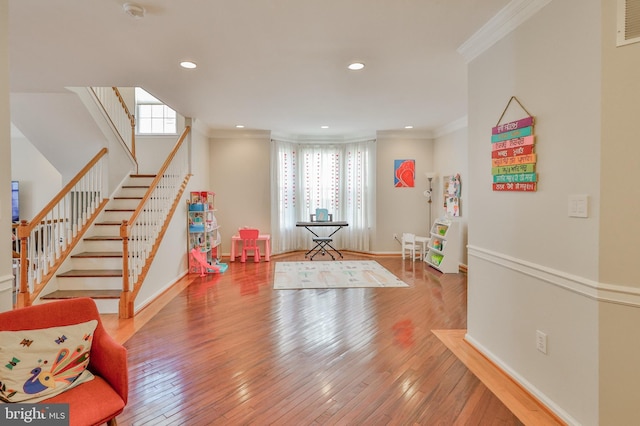 game room featuring ornamental molding, wood-type flooring, recessed lighting, and baseboards