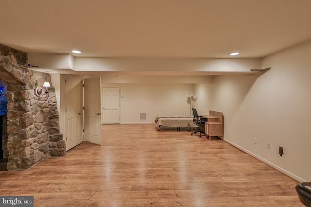finished basement with wood finished floors, recessed lighting, and baseboards