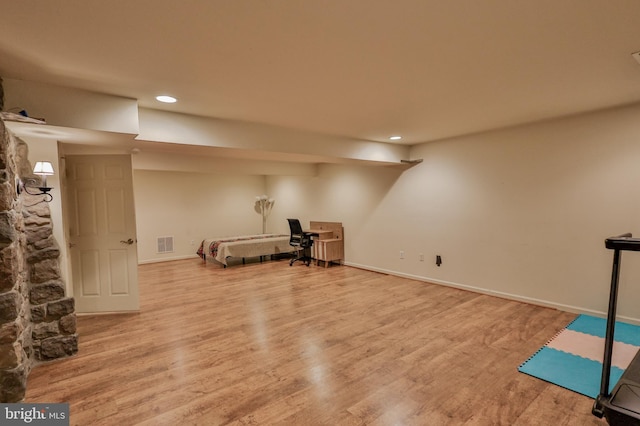 exercise area with wood finished floors, recessed lighting, and baseboards