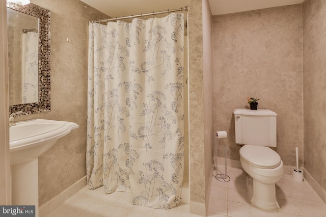 bathroom featuring tile patterned floors, toilet, and a shower with shower curtain