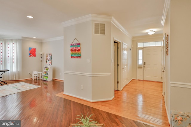 entrance foyer featuring light wood-type flooring, crown molding, baseboards, and recessed lighting