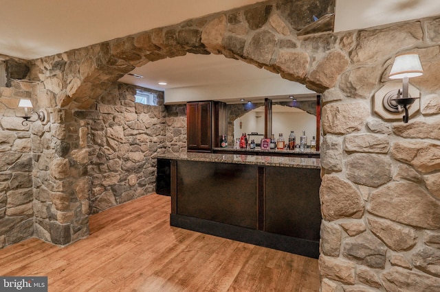 indoor dry bar with light wood-type flooring