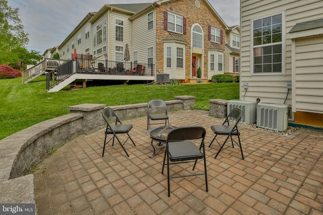 view of patio with central AC, a wooden deck, and stairway