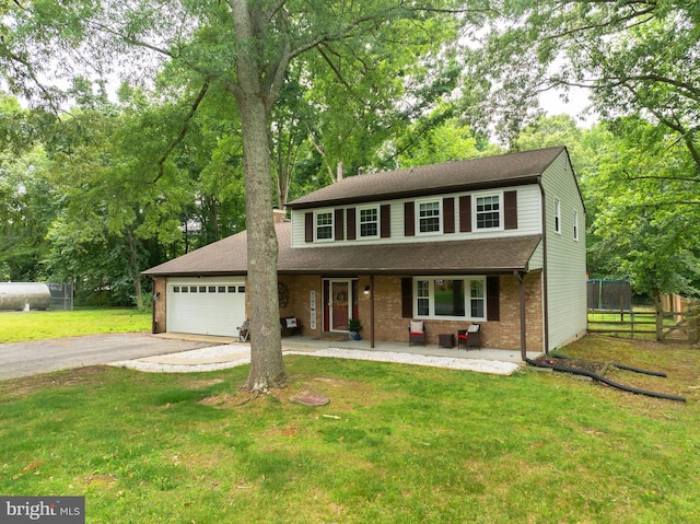 4017 Spring Valley Dr, White Plains, MD 20695 - traditional-style home with asphalt driveway, a porch, an attached garage, brick siding, and a shingled roof