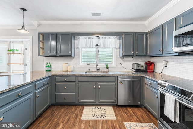 4017 Spring Valley Dr, White Plains, MD 20695 - kitchen featuring stainless steel appliances, a sink, crown molding, dark wood-style flooring, and backsplash