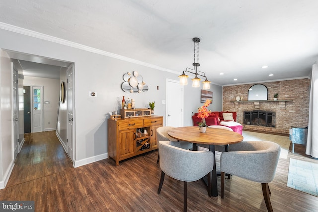 4017 Spring Valley Dr, White Plains, MD 20695 - dining space featuring dark wood-style flooring, baseboards, a brick fireplace, ornamental molding, and recessed lighting