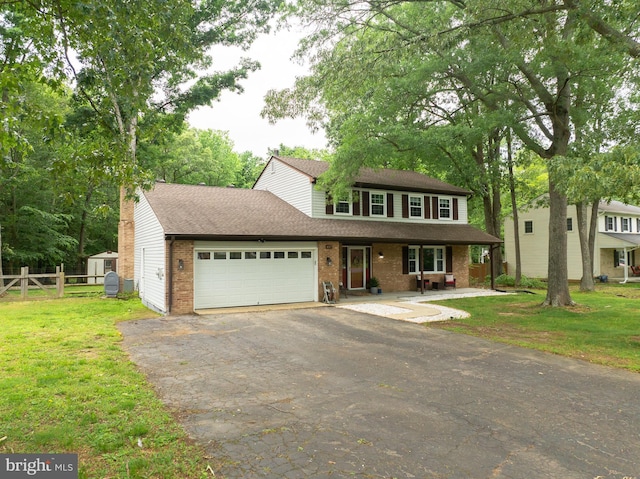 4017 Spring Valley Dr, White Plains, MD 20695 - view of front of home with driveway, brick siding, covered porch, a garage, and a shingled roof