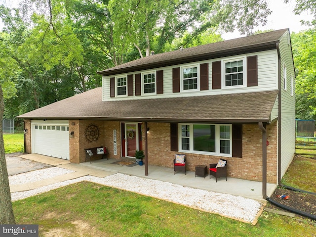 4017 Spring Valley Dr, White Plains, MD 20695 - traditional-style home featuring covered porch, a garage, driveway, and brick siding
