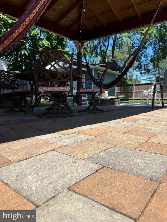 view of patio with fence and a gazebo