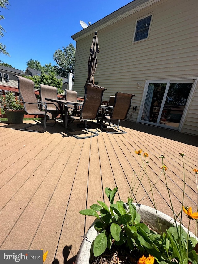 wooden terrace with outdoor dining space