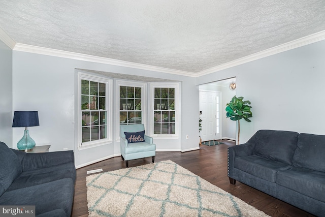 living room with a textured ceiling, dark wood-style flooring, crown molding, baseboards, and healthy amount of natural light