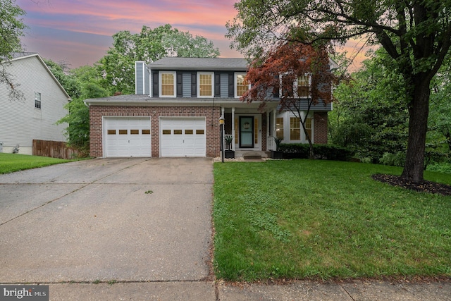 traditional-style home featuring driveway, a chimney, and brick siding