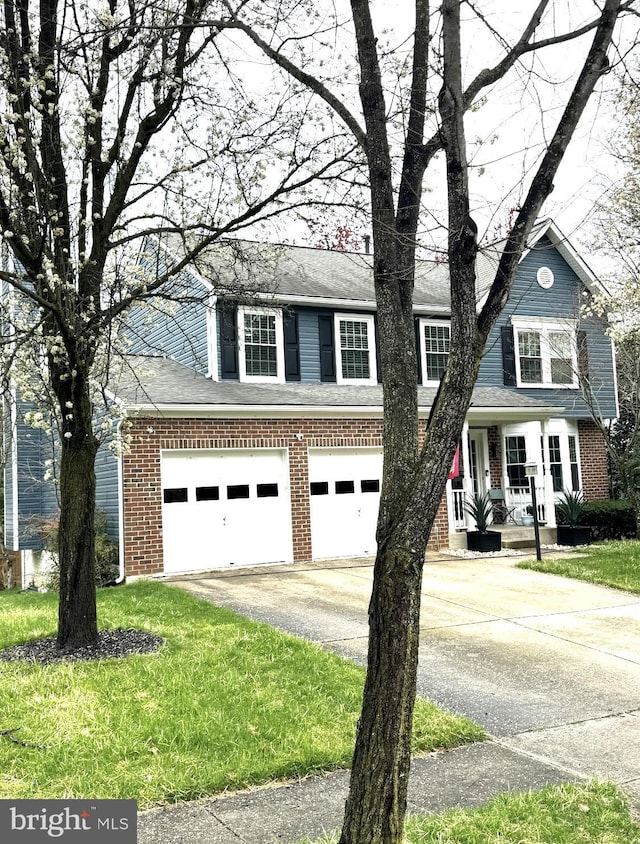 view of front of home featuring driveway, brick siding, a front lawn, and covered porch
