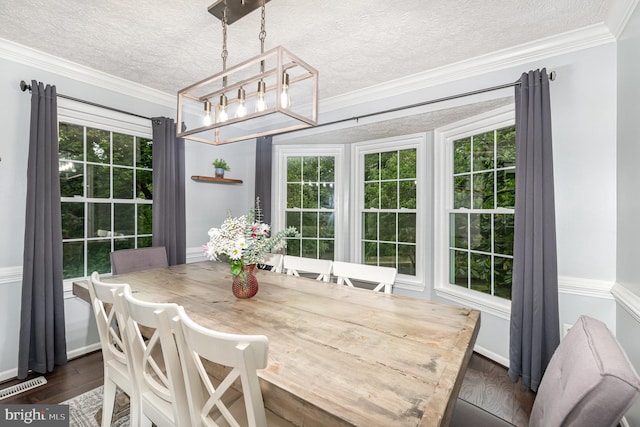 dining room with a chandelier, a textured ceiling, dark wood-type flooring, and ornamental molding