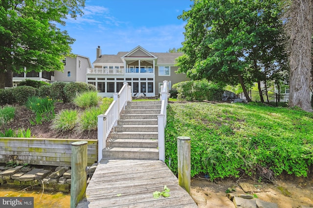 853 Imperial Rd, Arnold, MD 21012 - back of property featuring a balcony, a chimney, stairway, fence, and a sunroom