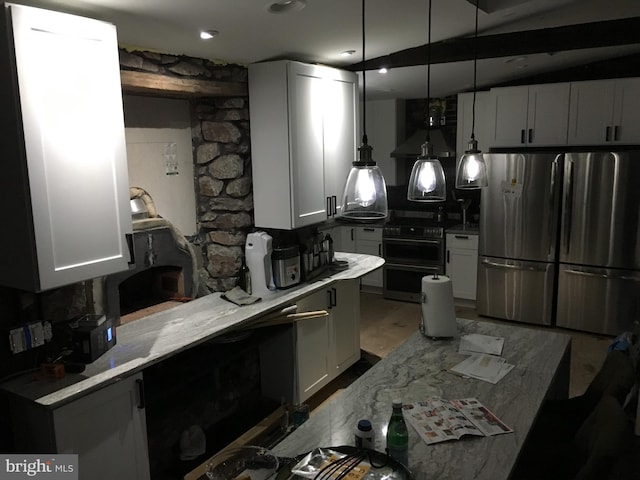 kitchen with appliances with stainless steel finishes, white cabinetry, decorative light fixtures, and light countertops