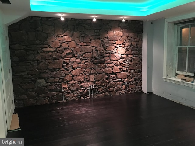 interior space with wood finished floors and baseboards