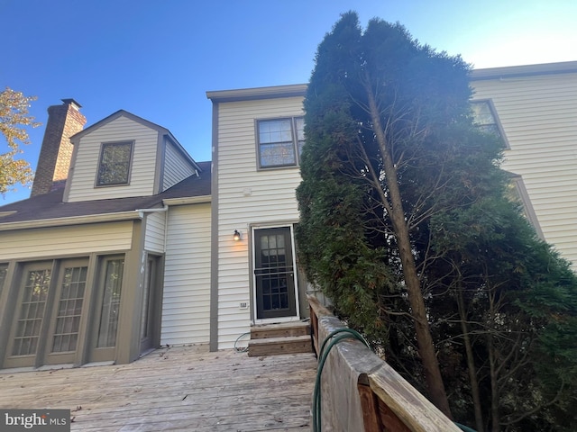 15202 Wetherburn Dr, Centreville, VA 20120 - view of front of house with a wooden deck and a chimney