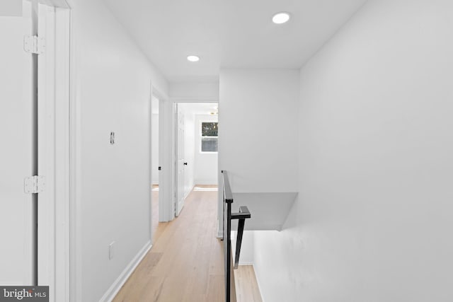 hall featuring recessed lighting, light wood-style floors, and baseboards
