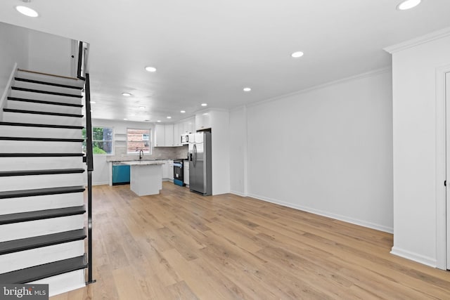 unfurnished living room featuring ornamental molding, recessed lighting, stairway, light wood-style flooring, and baseboards