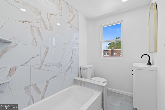 full bath with a tub to relax in, baseboards, vanity, marble look tile flooring, and toilet