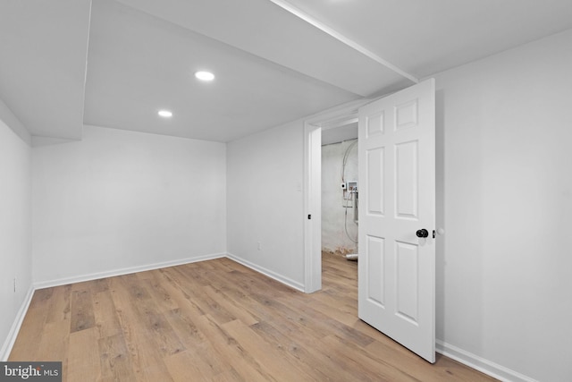 finished below grade area featuring baseboards, light wood-style floors, and recessed lighting