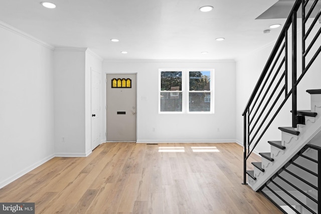 entrance foyer featuring crown molding, stairway, light wood-style flooring, recessed lighting, and baseboards