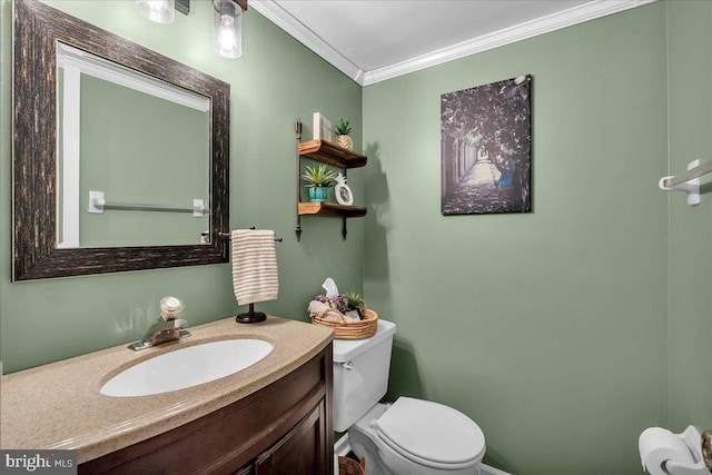 bathroom featuring ornamental molding, toilet, and vanity