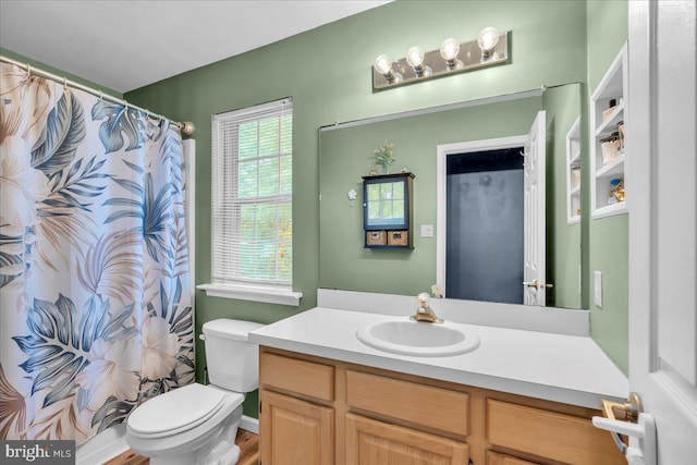 full bathroom featuring vanity, toilet, and curtained shower
