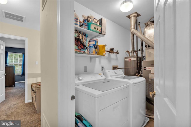laundry room with water heater, washer and dryer, and light colored carpet