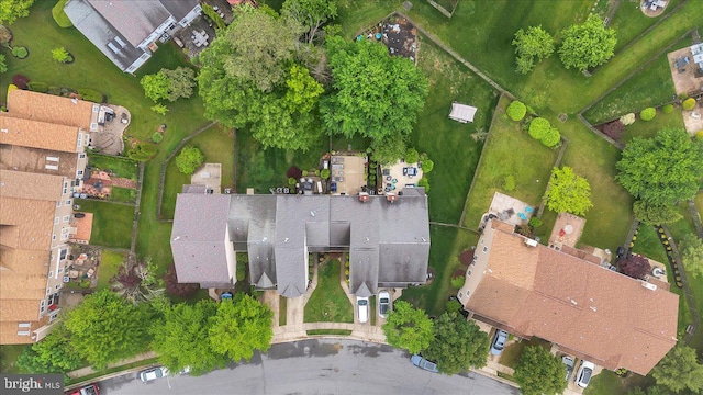 aerial view of property and surrounding area featuring nearby suburban area