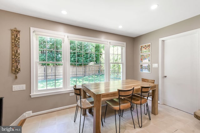 dining space with recessed lighting and baseboards
