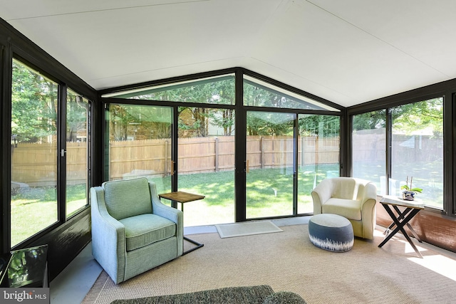 sunroom with plenty of natural light and lofted ceiling