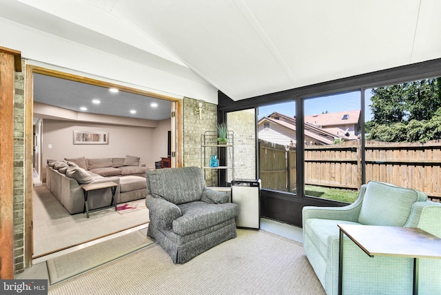 sunroom with an outdoor living space and vaulted ceiling