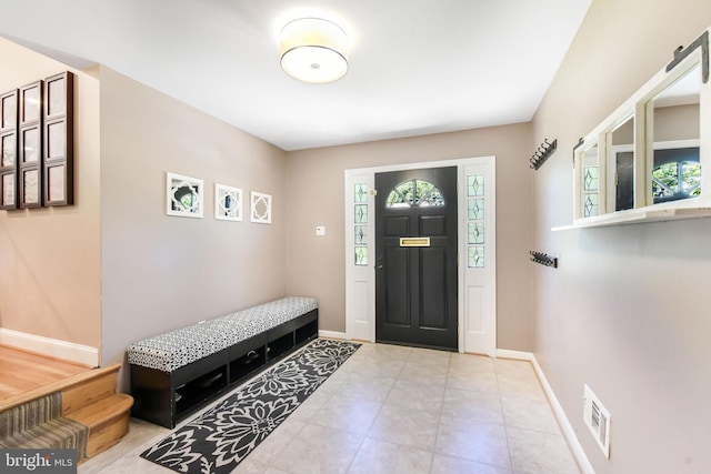 foyer entrance featuring baseboards