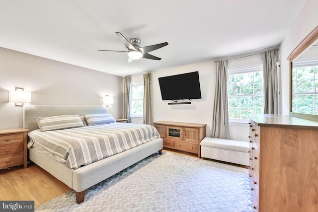 bedroom with light wood-style flooring and a ceiling fan