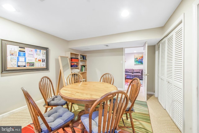 dining space featuring light carpet, baseboards, and recessed lighting