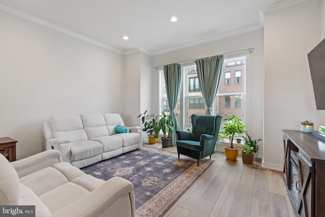 living room with crown molding, baseboards, light wood finished floors, and recessed lighting