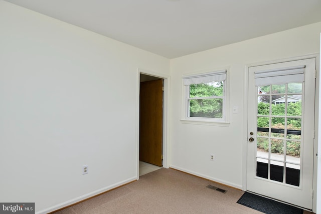 entryway with light colored carpet and baseboards