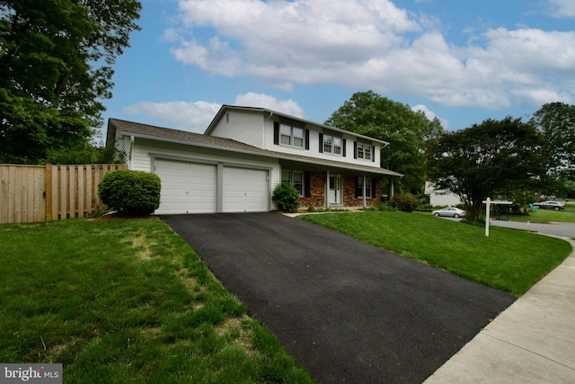 view of front of property featuring asphalt driveway, a garage, and covered porch