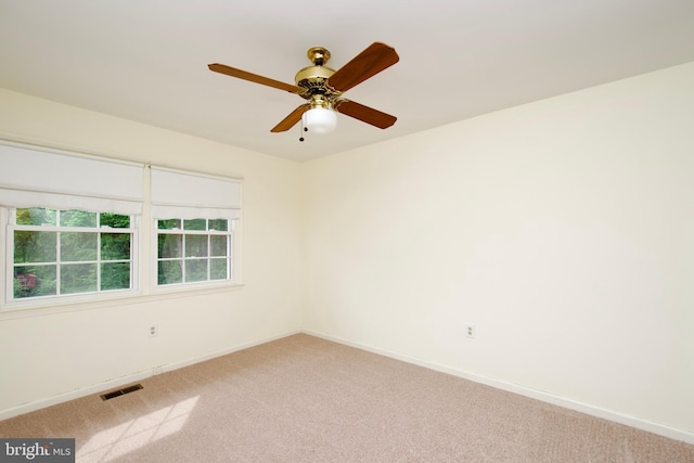 carpeted empty room with baseboards and ceiling fan