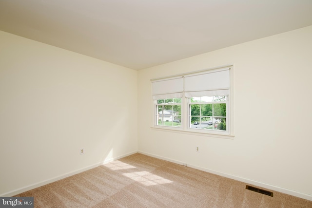 carpeted spare room with baseboards