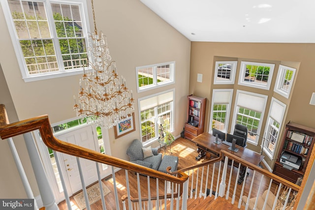 1123 Riverview Ln, Conshohocken, PA 19428 - living room featuring high vaulted ceiling, a chandelier, wood finished floors, stairs, and baseboards