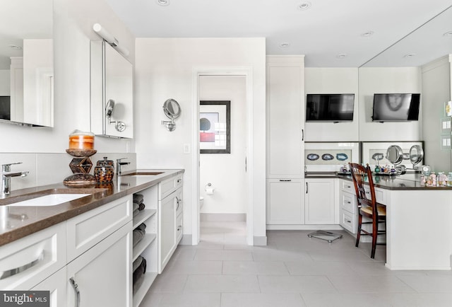1123 Riverview Ln, Conshohocken, PA 19428 - kitchen featuring a sink, white cabinets, and dark stone countertops