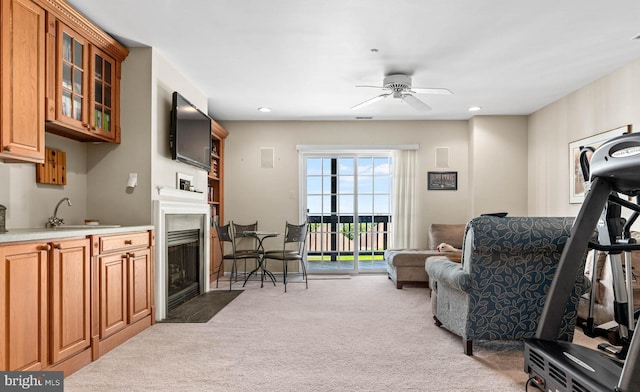 1123 Riverview Ln, Conshohocken, PA 19428 - carpeted living area featuring a sink, a fireplace with flush hearth, a ceiling fan, and recessed lighting