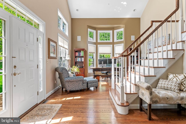 1123 Riverview Ln, Conshohocken, PA 19428 - foyer entrance featuring high vaulted ceiling, wood finished floors, stairs, and baseboards