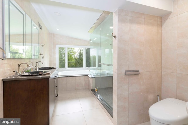bathroom with tile walls, tile patterned flooring, a bath, a stall shower, and toilet