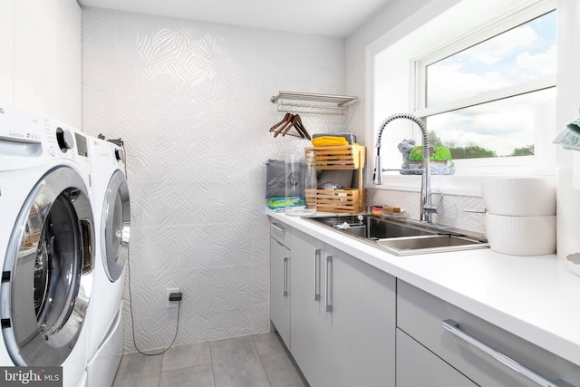 laundry room featuring cabinet space, independent washer and dryer, and wallpapered walls