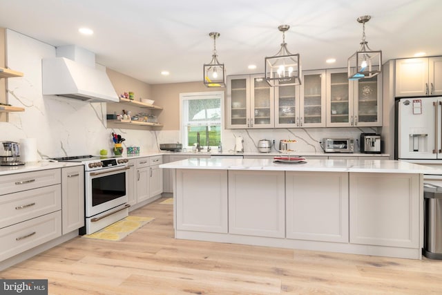 kitchen with white appliances, premium range hood, a kitchen island, backsplash, and recessed lighting